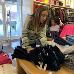 Gap Factory - Employee (Ashley) helping me find a size I want in jeans.