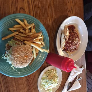 The Kill Devil Grill - Crispy fried flounder sandwich and the blue plate special, pasta with meat sauce. - American Near Me - Kill Devil Hills, North Carolina The Kill Devil Grill - Crispy fried flounder sandwich and the blue plate special, pasta with meat sauce. - American Near Me - Kill Devil Hills, North Carolina
