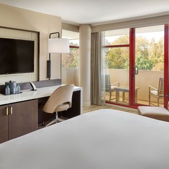 Emory Conference Center Hotel - Guest room featuring modern workspace, lounge seating, large television, and balcony views at Emory Conference Center Hotel i... - Hotels Near Me - Atlanta, Georgia Emory Conference Center Hotel - Guest room featuring modern workspace, lounge seating, large television, and balcony views at Emory Conference Center Hotel i... - Hotels Near Me - Atlanta, Georgia
