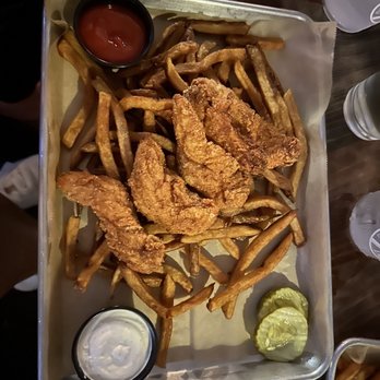 Dunedin Brewery - a tray of fried chicken wings and french fries - Breweries Near Me - Dunedin, Florida