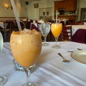 Thai Seafood - a glass of orange juice on a table - Thai Near Me - Webster, Texas Thai Seafood - a glass of orange juice on a table - Thai Near Me - Webster, Texas