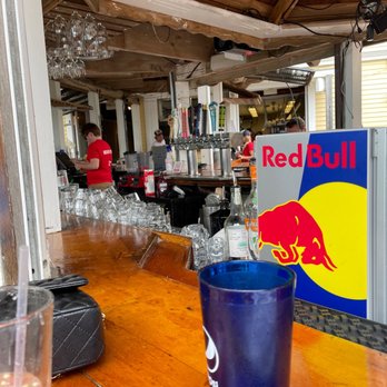 Sand Bar & Grill - a red bull sign in the background - Seafood Near Me - Oak Bluffs, Massachusetts