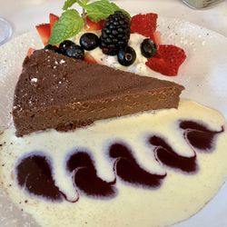 Duner's Restaurant - Flourless Chocolate Cake served with whipped cream, and crème anglaise with a raspberry sauce