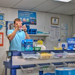 SunSpot Pool & Patio - Brandon, one of our water chemistry specialists, assesses one of our customer's Pool Water for chemical balance.