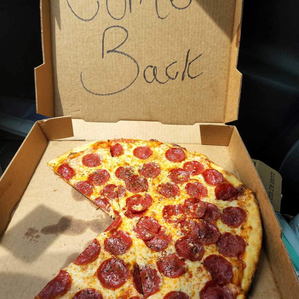 a half eaten pizza in a box a half eaten pizza in a box