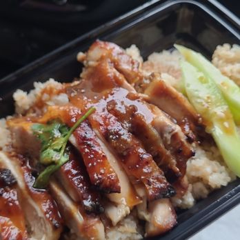 Gai Kitchen - Quick snap of thai roasted chicken over garlic rice with sliced cucumbers. - Thai Near Me - New York, New York