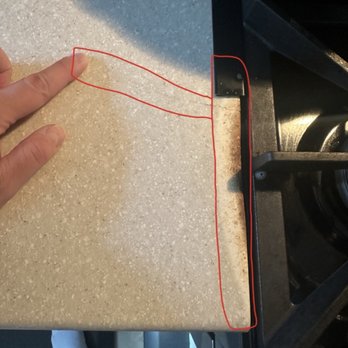 Back To Perfection - This is where the stove burned the counter and it cracked the Korean to where I'm pointing, and what circled in red all of that was fixed - Refinishing Services Near Me