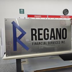 FASTSIGNS - 2 layer wall sign  brushed metal with clear acrylic face mounted with standoffs.
