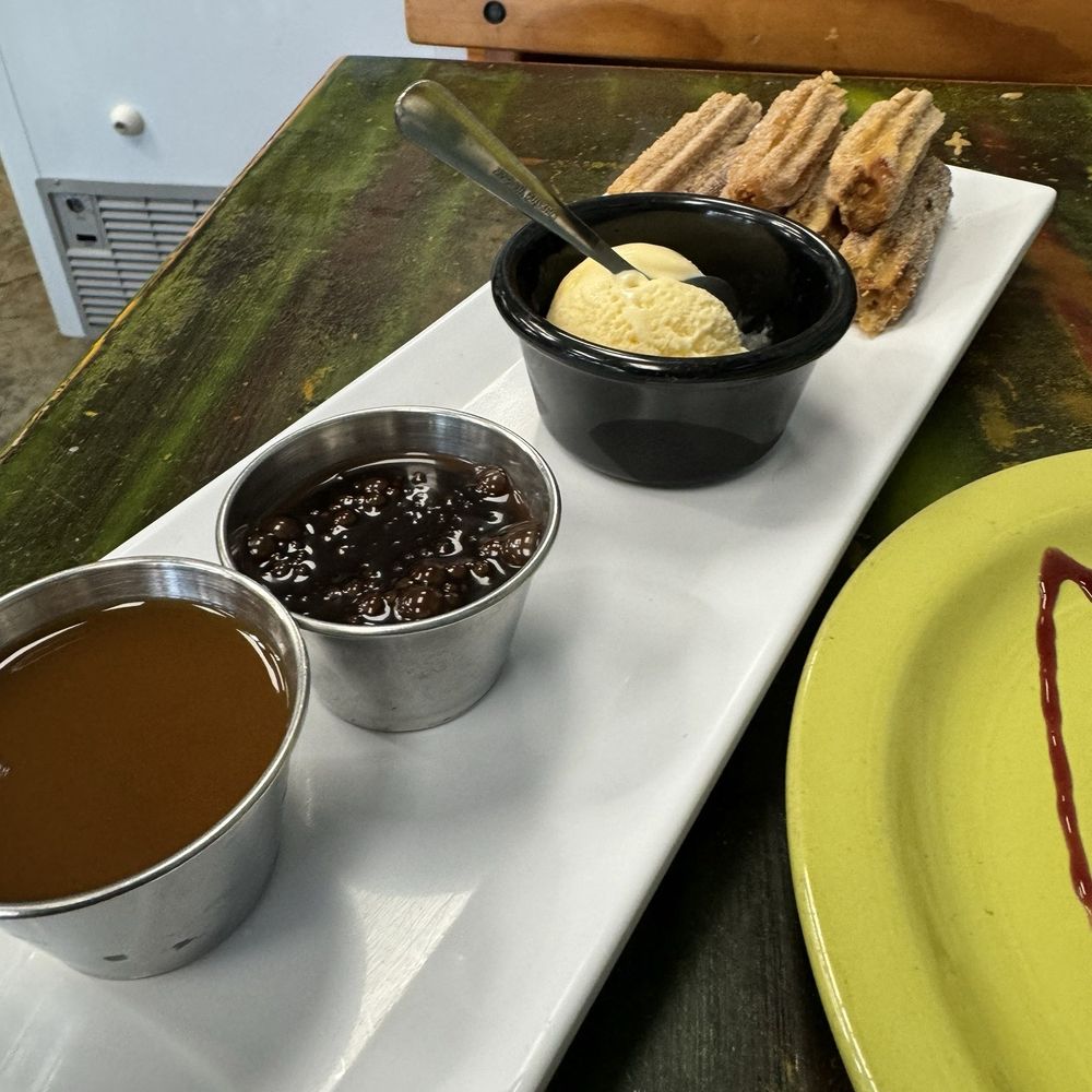 Churros with sauces and ice-cream. Churros with sauces and ice-cream.