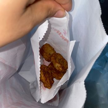 Dunkin' -  a person holding a bag of fried food - Donuts Near Me - Manhattan, Kansas