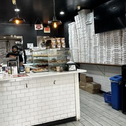 Krave It Pizza & Sandwich Joint - Pizza boxes stacked to the ceiling
