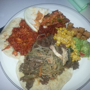 Chi'Lantro - Jap chae, bulgogi taco, spicy chicken taco, spicy pork on bao, side sample of their tofu, tasty corn, side of guac - Korean Near Me - Austin, Texas