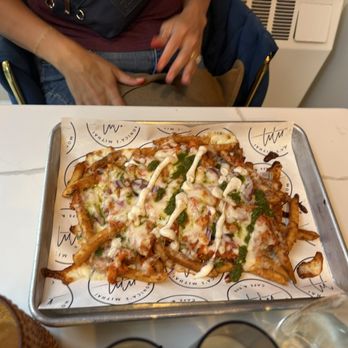 Monica’s Mithai Cafe & Bar - Off-physical menu option - butter chicken poutine which is also gluten free - Indian Near Me - Andover, Massachusetts Monica’s Mithai Cafe & Bar - Off-physical menu option - butter chicken poutine which is also gluten free - Indian Near Me - Andover, Massachusetts