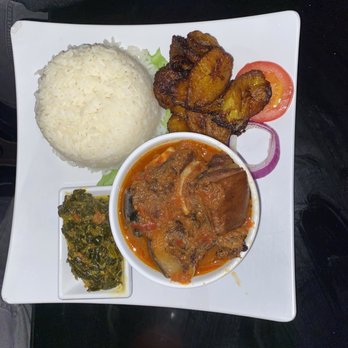 Aria Suya Kitchen - Rice and stew with goat meat and plantains and fried spinach !!! - African Near Me - Houston, Texas Aria Suya Kitchen - Rice and stew with goat meat and plantains and fried spinach !!! - African Near Me - Houston, Texas
