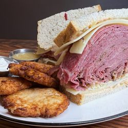 Roasters 'N Toasters - Massive Deli Sandwich 6 oz. hot pastrami and 6 oz. hot corned beef piled high on rye with Swiss cheese ,Russian dressing, and coleslaw.
