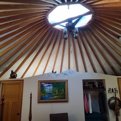 Yurtel-Veneta - Interior of the Yogi Bear themed yurt. Note the painted snow capped peaks on the wall dividing bedroom from bathroom!
