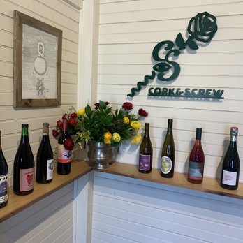 Cork & Screw - bottles of wine lined up on a shelf - Beer, Wine & Spirits Near Me - Austin, Texas