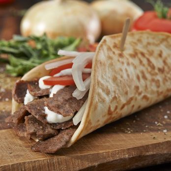 Olga's Kitchen - a burrito on a cutting board - Sandwiches Near Me - Brighton, Michigan Olga's Kitchen - a burrito on a cutting board - Sandwiches Near Me - Brighton, Michigan