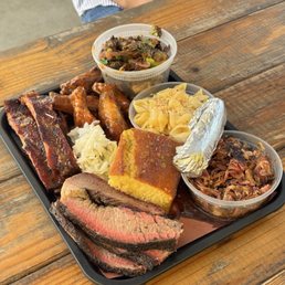 Tray for two - platter filled with cornbread, Mac and cheese, Brussels, wings, brisket, ribs, slaw. Tray for two - platter filled with cornbread, Mac and cheese, Brussels, wings, brisket, ribs, slaw.