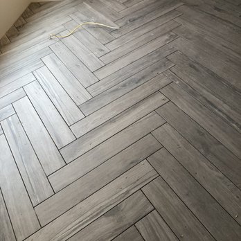 Tommy Floors - a picture of a herringle wood floor - Flooring Near Me