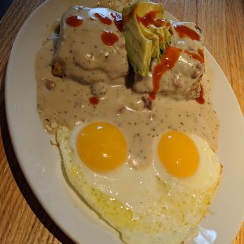 Caroline - Biscuits and sausage cream gravy with fried eggs, Cholula, and Avocado - Bakeries Near Me - Austin, Texas