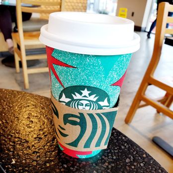 Starbucks - a starbucks cup sitting on a table - Coffee & Tea Near Me - Los Angeles, California Starbucks - a starbucks cup sitting on a table - Coffee & Tea Near Me - Los Angeles, California