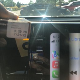 a hand holding a ticket in a car