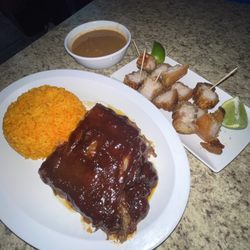 La Gran Parada - Barbecue pork ribs and Pork crackling with yellow rice and red beans.