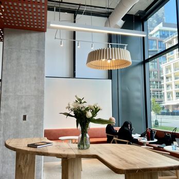 Lazy Barista - a table with a vase of flowers on it - Coffee & Tea Near Me - Toronto, Ontario Lazy Barista - a table with a vase of flowers on it - Coffee & Tea Near Me - Toronto, Ontario