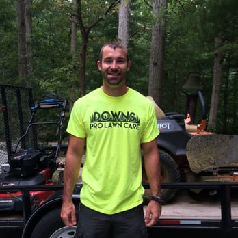 Downs Pro Lawn Care - a man standing in front of a tractor - Landscaping Near Me Downs Pro Lawn Care - a man standing in front of a tractor - Landscaping Near Me