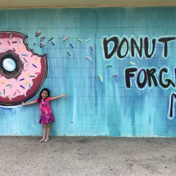 Coleman Donuts - a little girl standing in front of a donut wall - Donuts Near Me - Coleman, Texas Coleman Donuts - a little girl standing in front of a donut wall - Donuts Near Me - Coleman, Texas