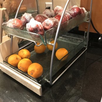 Apples in plastic and styrofoam and plastic.