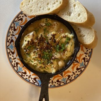 Hola - a bowl of soup with bread on a plate - Tapas Bars Near Me - San Antonio, Texas