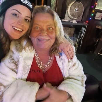 Signal Lounge - a woman and a woman sitting together - Dive Bars Near Me - Orange, California