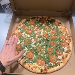 Large pizza with tomato, spinach, and green pepper Large pizza with tomato, spinach, and green pepper