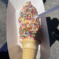 Marcellus Ice Cream - orange & vanilla twist with rainbow sprinkles