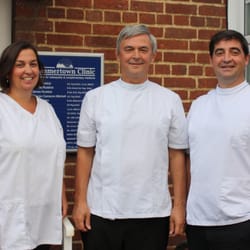 Summertown Clinic - Joanna, David, and James pose for a photo outside the clinic which they run.