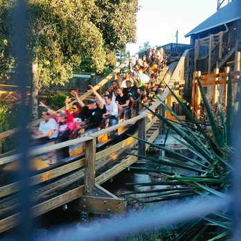 GhostRider - It's all hands up as the Millennium Flyer train departs the station on its way to the chain lift! - Amusement Parks Near Me - Buena Park, California GhostRider - It's all hands up as the Millennium Flyer train departs the station on its way to the chain lift! - Amusement Parks Near Me - Buena Park, California
