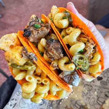 I Heart Mac & Cheese - hand holding a taco - American Near Me - Bismarck, North Dakota I Heart Mac & Cheese - hand holding a taco - American Near Me - Bismarck, North Dakota