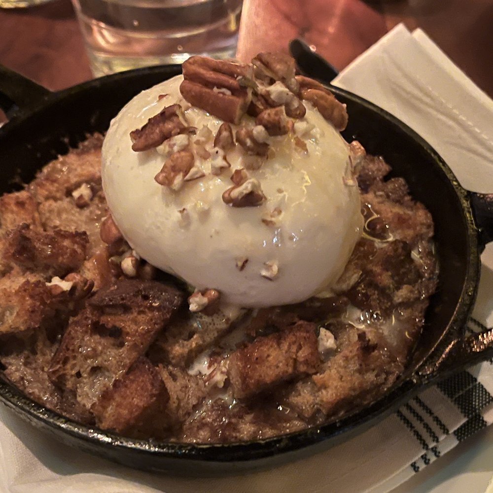 Corinne Austin - Delicious bread pudding in a cast iron griddle - New American Near Me - Austin, Texas Corinne Austin - Delicious bread pudding in a cast iron griddle - New American Near Me - Austin, Texas
