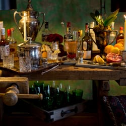 Trouvaille Home - 19th century eastern European work bench set as a bar using vintage trophies and sterling sliver.