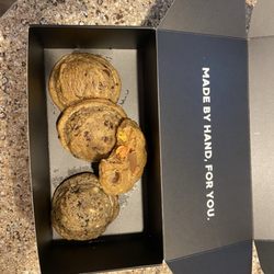 Thick Cookie Co - Peanut butter cookie (with a bit missing), 2 chocolate chips on the left & Oreo cookie pieces cookie to the right