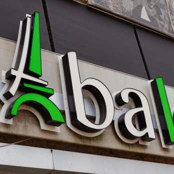 Uptown - The image shows a storefront sign with the logo of a retail or grocery store, featuring green and black lettering on a white background. - Municipality Near Me - Chicago, Illinois