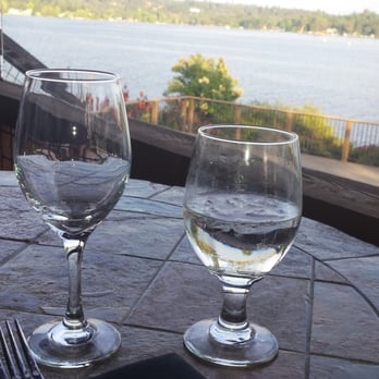 Magnolia Pointe Grill - two wine glasses on a table overlooking a lake - American Near Me - Auburn, California Magnolia Pointe Grill - two wine glasses on a table overlooking a lake - American Near Me - Auburn, California