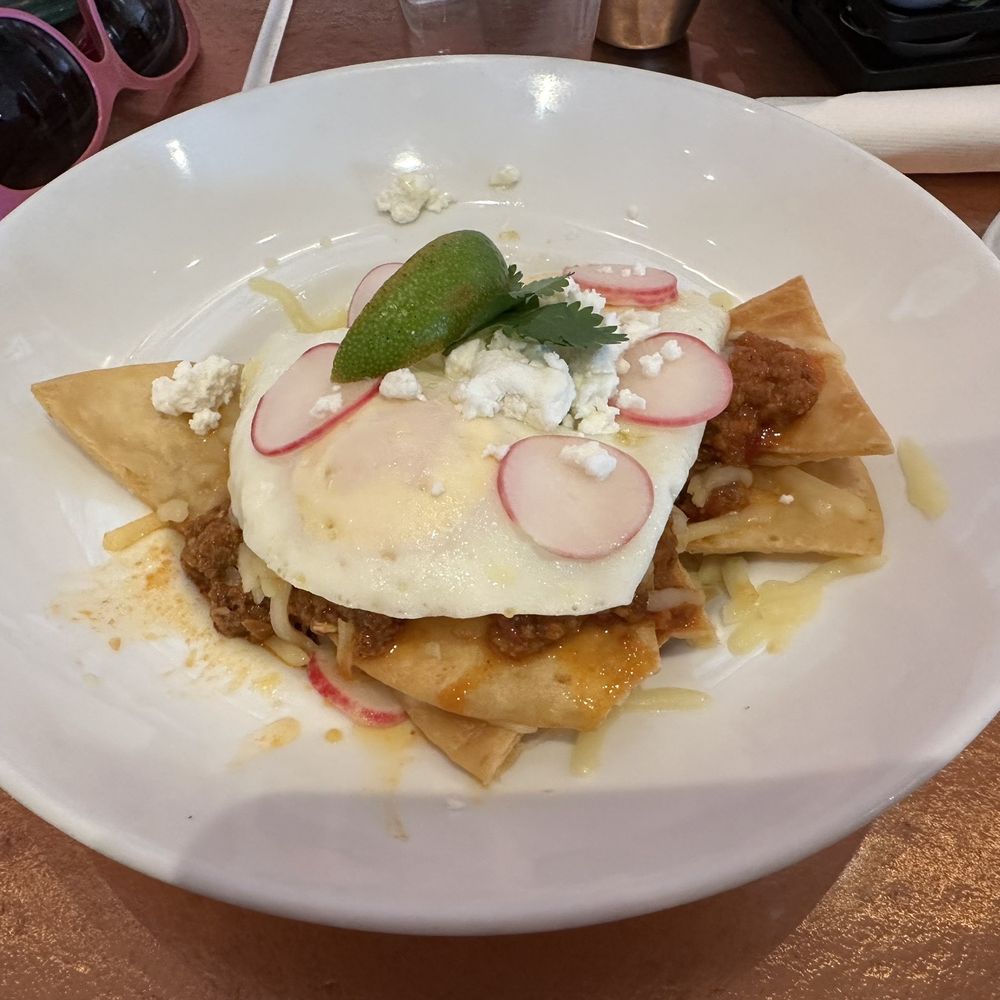 Another Broken Egg Cafe - Chilaquiles $14.99 (pictured without onions) - Breakfast & Brunch Near Me - The Colony, Texas Another Broken Egg Cafe - Chilaquiles $14.99 (pictured without onions) - Breakfast & Brunch Near Me - The Colony, Texas