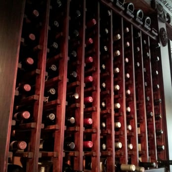 Four Square Restaurant & Bar - a wine rack full of wine bottles - American Near Me - Braintree, Massachusetts