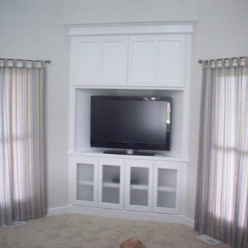 CA Custom Woodworking - a dog laying in front of a tv - General Contractors Near Me - Oswego, Illinois