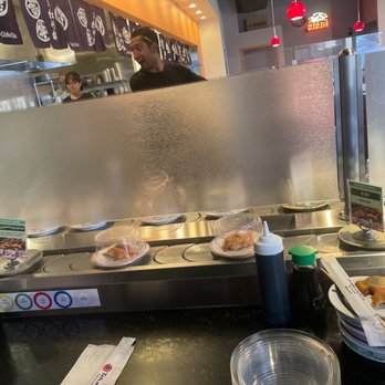 Teharu Sushi - a counter with plates of food on it - Sushi Bars Near Me - Mesa, Arizona Teharu Sushi - a counter with plates of food on it - Sushi Bars Near Me - Mesa, Arizona
