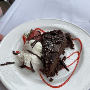 Tisha's Cape May - Flourless Chocolate Cake raspberry chocolate drizzle with ice cream - Seafood Near Me - Cape May, New Jersey Tisha's Cape May - Flourless Chocolate Cake raspberry chocolate drizzle with ice cream - Seafood Near Me - Cape May, New Jersey