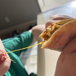 Vista Ridge Grill - My kiddo enjoying the cheesy goodness of his bacon egg breakfast taco!